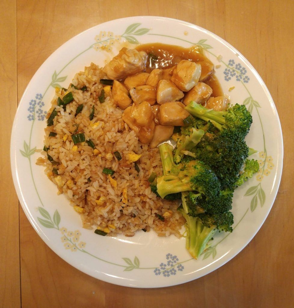 Orange chicken with fried rice and cheesy broccoli.