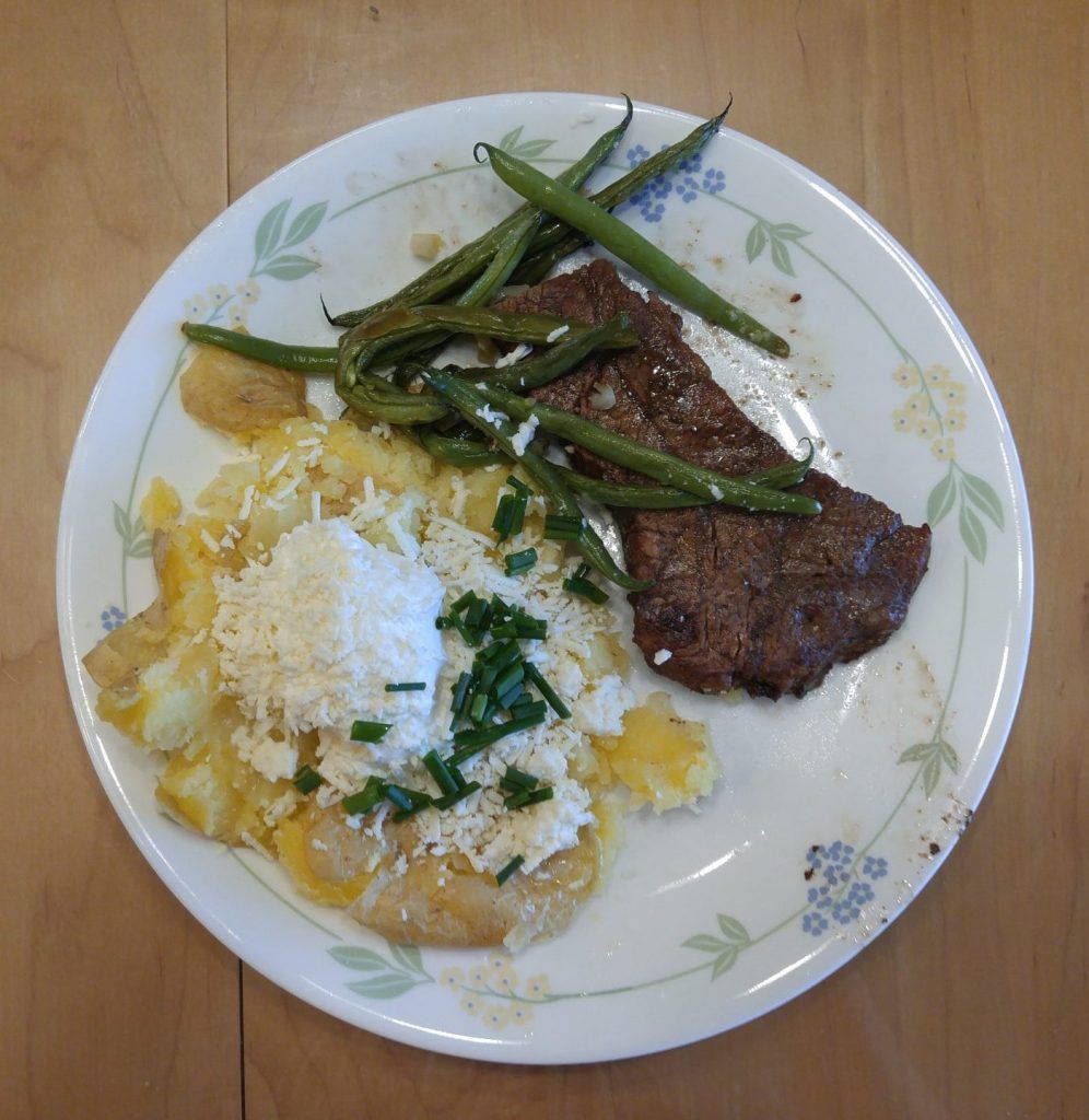 Steak with yukon gold baked potato and garlic roasted green beans.
