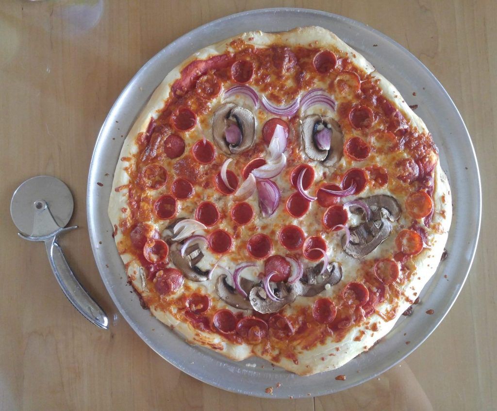 Homemade pepperoni , mushroom and onion pizza.
