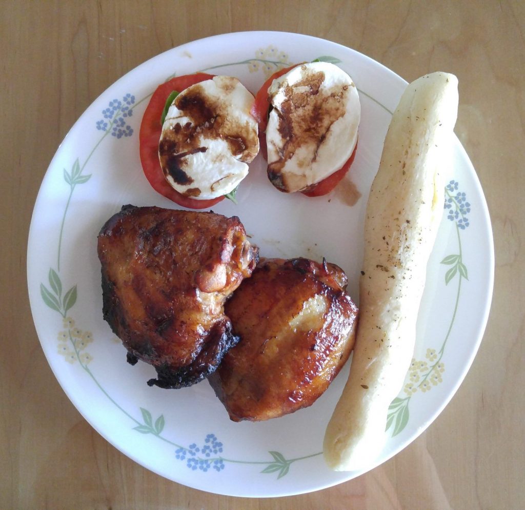 Grilled BBQ Chicken, caprese salad and breadsticks.